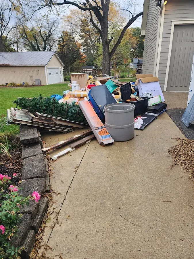 Dumpster being loaded with debris for Estate Cleanout Dumpster Rental in Mebane